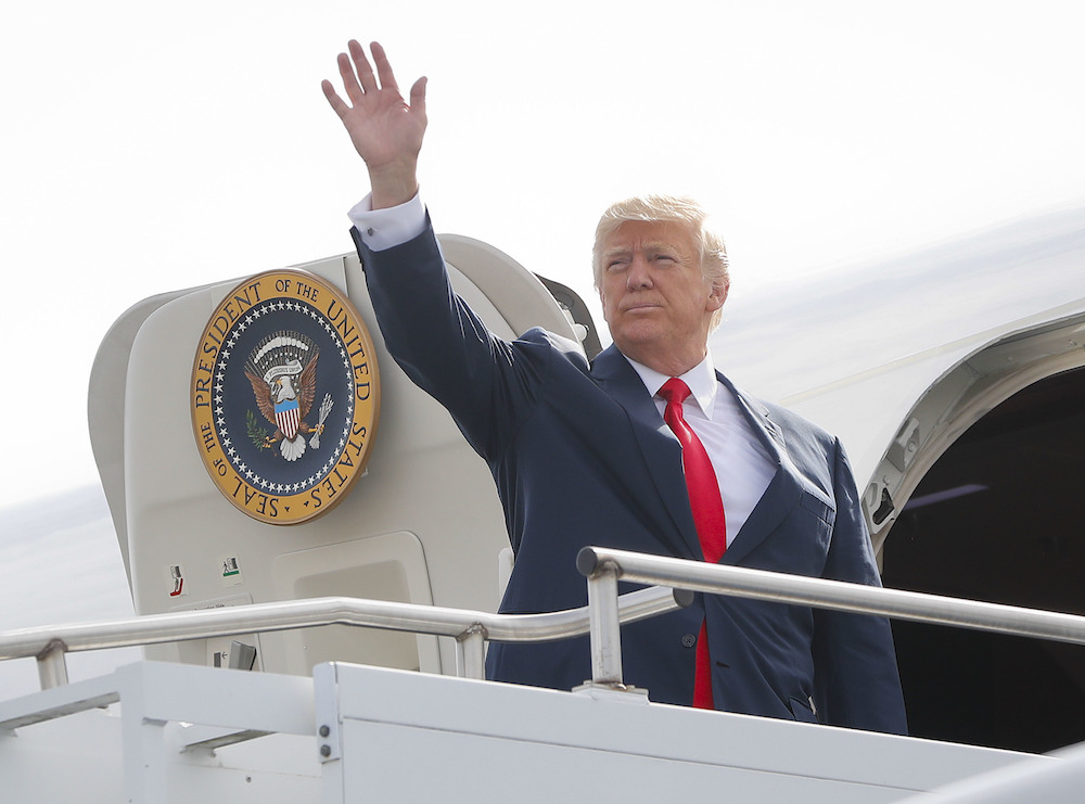 Trump returns to Washington with target on China, amid Charlottesville turmoil