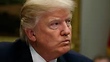 Americans sharply divided along partisan lines over travel ban, Trump: CBS News poll